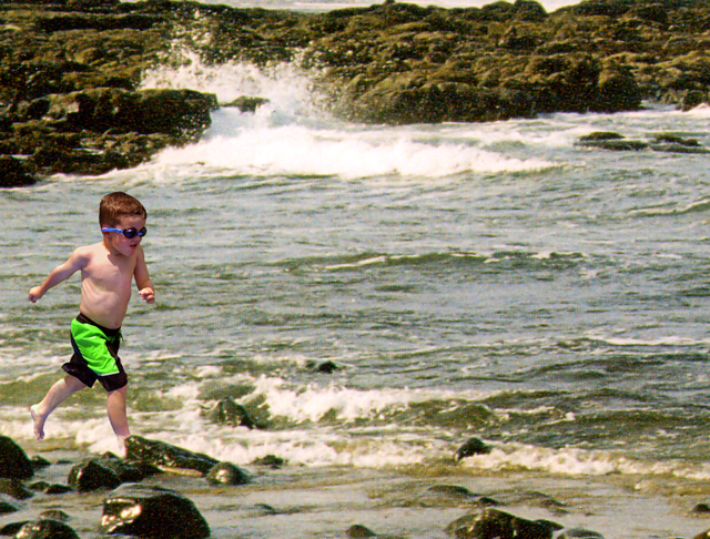 Running boy on beach